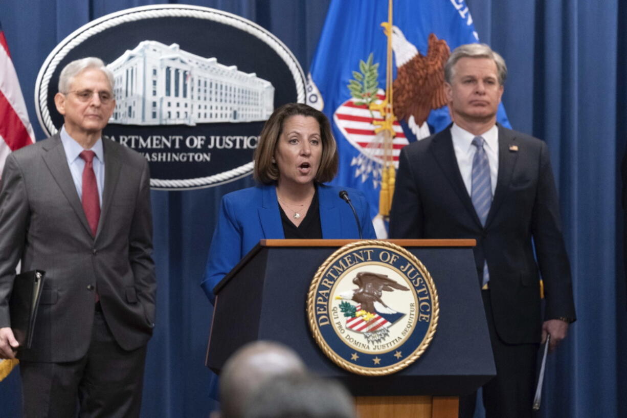 Deputy Attorney General Lisa Monaco flanked by Attorney General Merrick Garland, left, and Federal Bureau of Investigation (FBI) Director Christopher Wray speaks during a news conference to announce an international ransomware enforcement action, at the Department of Justice in Washington, Thursday, Jan. 26, 2023. The FBI has seized the website of a prolific ransomware gang that has heavily targeted hospitals and other healthcare providers.