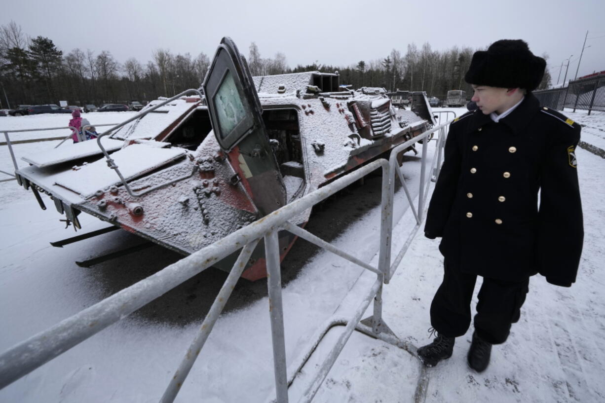 A student of navy military school visits an exhibition of tanks and APCs of Ukrainian armed forces damaged and captured during the fighting at an exhibition at the museum "Breakthrough of the Siege of Leningrad" in Kirovsk, about 30 kilometres (19 miles) east of St. Petersburg, Russia, Sunday, Jan. 22, 2023.