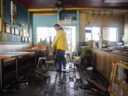 Dominic King, owner of My Thai Beach, surveys storm damage that destroyed his restaurant in Capitola, Calif., Thursday, Jan. 5, 2023. Damaging hurricane-force winds, surging surf and heavy rains from a powerful "atmospheric river" pounded California on Thursday, knocking out power to tens of thousands, causing flooding, and contributing to the deaths of at least two people, including a child whose home was hit by a falling tree.