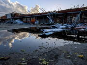 The roof of a local businesses is strewn about after a tornado passed through Selma, Ala., Thursday, Jan. 12, 2023.