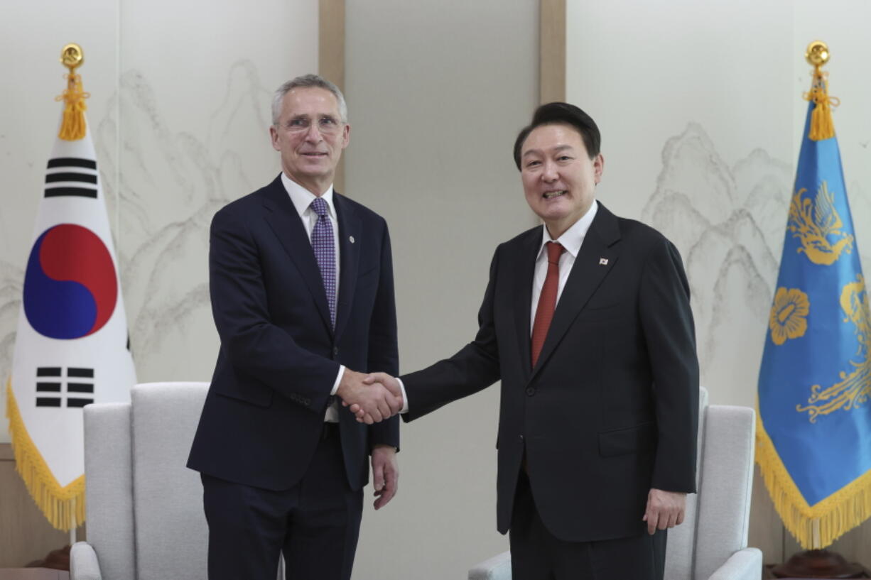 South Korean President Yoon Suk Yeol, right, shakes hands with NATO Secretary-General Jens Stoltenberg during a meeting at the presidential office in Seoul, South Korea, Monday, Jan. 30, 2023.