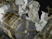 This photo provided by NASA, astronauts NASA's Nicole Mann and Japan's Koichi Wakata venture out on a spacewalk at the International Space Station on Friday, Jan. 20, 2023.  Their job was to install support struts for small solar panels launching this summer, part of a continuing effort by NASA to expand the space station's power grid.