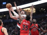 Portland Trail Blazers guard Damian Lillard, right, dribbles as Toronto Raptors forward Scottie Barnes, left, defends during first-half NBA basketball game action in Toronto, Sunday, Jan. 8, 2023.