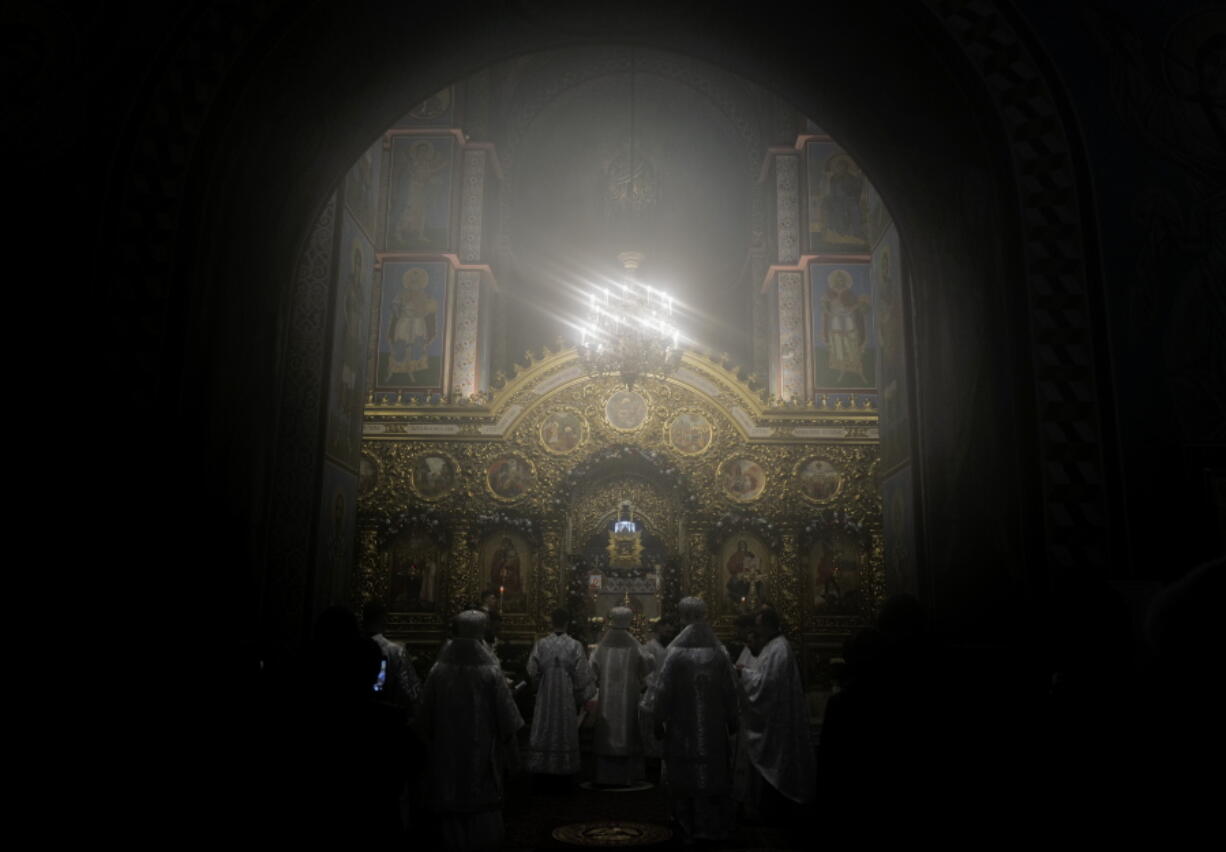 Ukrainian priests holding a service before the start of the Orthodox Chrismas in the St. Michael's Monastery of Kyiv, Ukraine, Friday, Jan. 6, 2023. Russian President Vladimir Putin on Thursday ordered Moscow's armed forces to observe a 36-hour cease-fire in Ukraine this weekend for the Russian Orthodox Christmas holiday, but Ukrainian President Volodymyr Zelenskyy questioned the Kremlin's intentions, accusing the Kremlin of planning the fighting pause "to continue the war with renewed vigor".