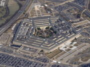 FILE - The Pentagon is seen from Air Force One as it flies over Washington, March 2, 2022. The Pentagon has formally dropped its COVID-19 vaccination mandate, but a new memo signed by Defense Secretary Lloyd Austin also gives commanders some discretion in how or whether to deploy troops who are not vaccinated.