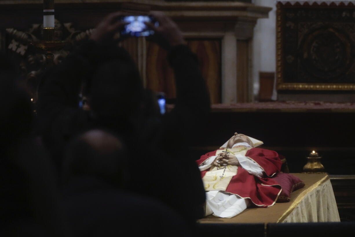 People line up to pay their respect to Pope Emeritus Benedict XVI lying out in state inside St. Peter's Basilica at The Vatican, Monday, Jan. 2, 2023. Benedict XVI, the German theologian who will be remembered as the first pope in 600 years to resign, has died, the Vatican announced Saturday. He was 95.