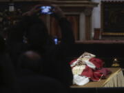 People line up to pay their respect to Pope Emeritus Benedict XVI lying out in state inside St. Peter's Basilica at The Vatican, Monday, Jan. 2, 2023. Benedict XVI, the German theologian who will be remembered as the first pope in 600 years to resign, has died, the Vatican announced Saturday. He was 95.