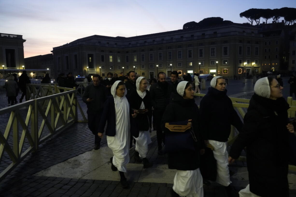 Nuns arrive at dawn to view the body of Pope Emeritus Benedict XVI as it lies in state in St. Peter's Basilica at the Vatican, Wednesday, Jan. 4, 2023. The Vatican announced that Pope Benedict died on Dec. 31, 2022, aged 95, and that his funeral will be held on Thursday, Jan. 5, 2023.