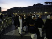 Nuns arrive at dawn to view the body of Pope Emeritus Benedict XVI as it lies in state in St. Peter's Basilica at the Vatican, Wednesday, Jan. 4, 2023. The Vatican announced that Pope Benedict died on Dec. 31, 2022, aged 95, and that his funeral will be held on Thursday, Jan. 5, 2023.