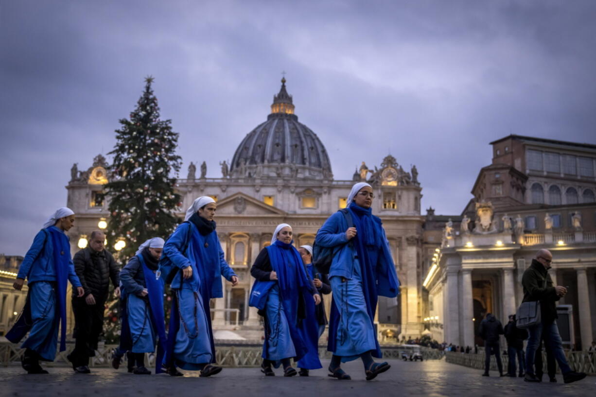 Nuns arrive at dawn to view the body of Pope Emeritus Benedict XVI as it lies in state in St. Peter's Basilica at the Vatican, Tuesday, Jan. 3, 2023. The Vatican announced that Pope Benedict died on Dec. 31, 2022, aged 95, and that his funeral will be held on Thursday, Jan. 5, 2023.