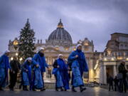 Nuns arrive at dawn to view the body of Pope Emeritus Benedict XVI as it lies in state in St. Peter's Basilica at the Vatican, Tuesday, Jan. 3, 2023. The Vatican announced that Pope Benedict died on Dec. 31, 2022, aged 95, and that his funeral will be held on Thursday, Jan. 5, 2023.