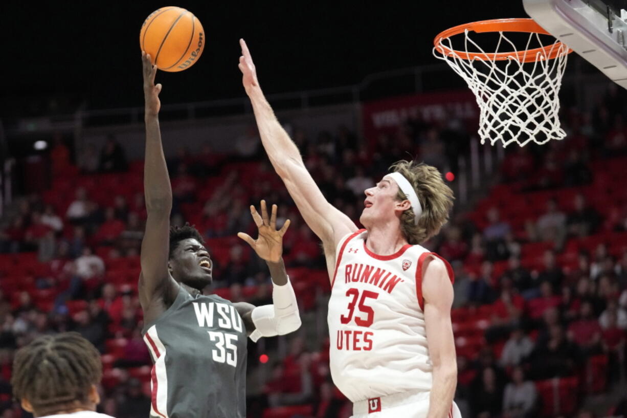 Utah center Branden Carlson (35) defends against Washington State forward Mouhamed Gueye (35) during the first half of an NCAA college basketball game Thursday, Jan. 19, 2023, in Salt Lake City.