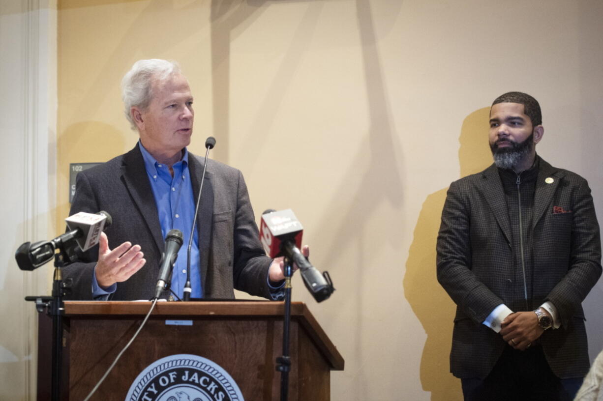 FILE - Ted Henifin, left, the City of Jackson water system third-party administrator, addresses media questions during a news conference at City Hall as Jackson Mayor Chokwe Antar Lumumba listens on Dec. 5, 2022, in Jackson, Miss. A bill before the Mississippi Legislature that would transfer the capital city's troubled water system to a new regional entity could be motivated by a desire by state officials to access a large pot of federal dollars earmarked for the city, according to Henifin, Jackson's federally appointed water operator said Wednesday.