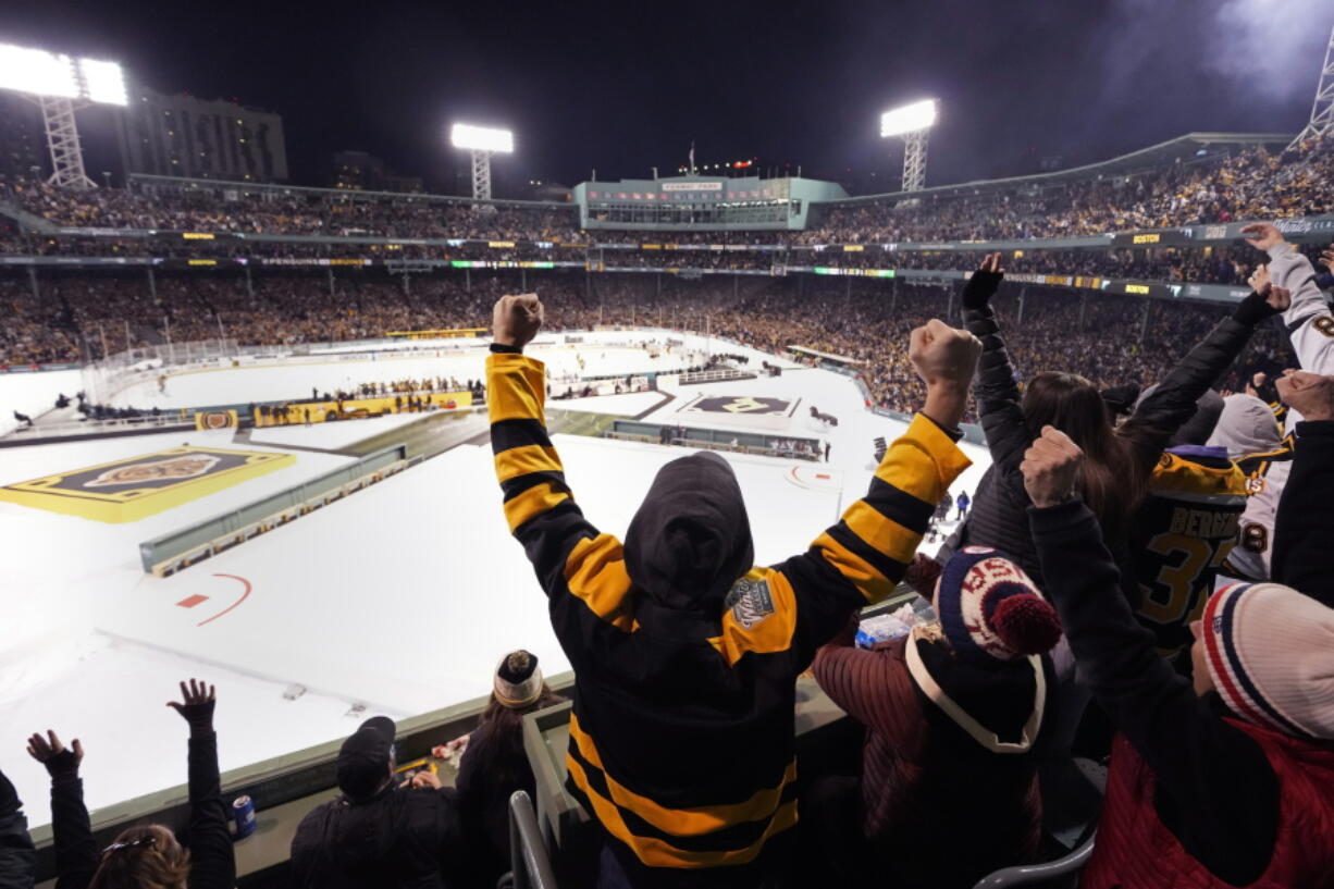 Fans celebrate after a goal by Boston Bruins left wing Jake DeBrusk, his second of the hockey game, during the third period of the NHL Winter Classic at Fenway Park, Monday, Jan. 2, 2023, in Boston.