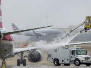 An American Airlines aircraft undergoes deicing procedures on Monday, Jan. 30, 2023, at Dallas/Fort Worth International Airport in Texas.