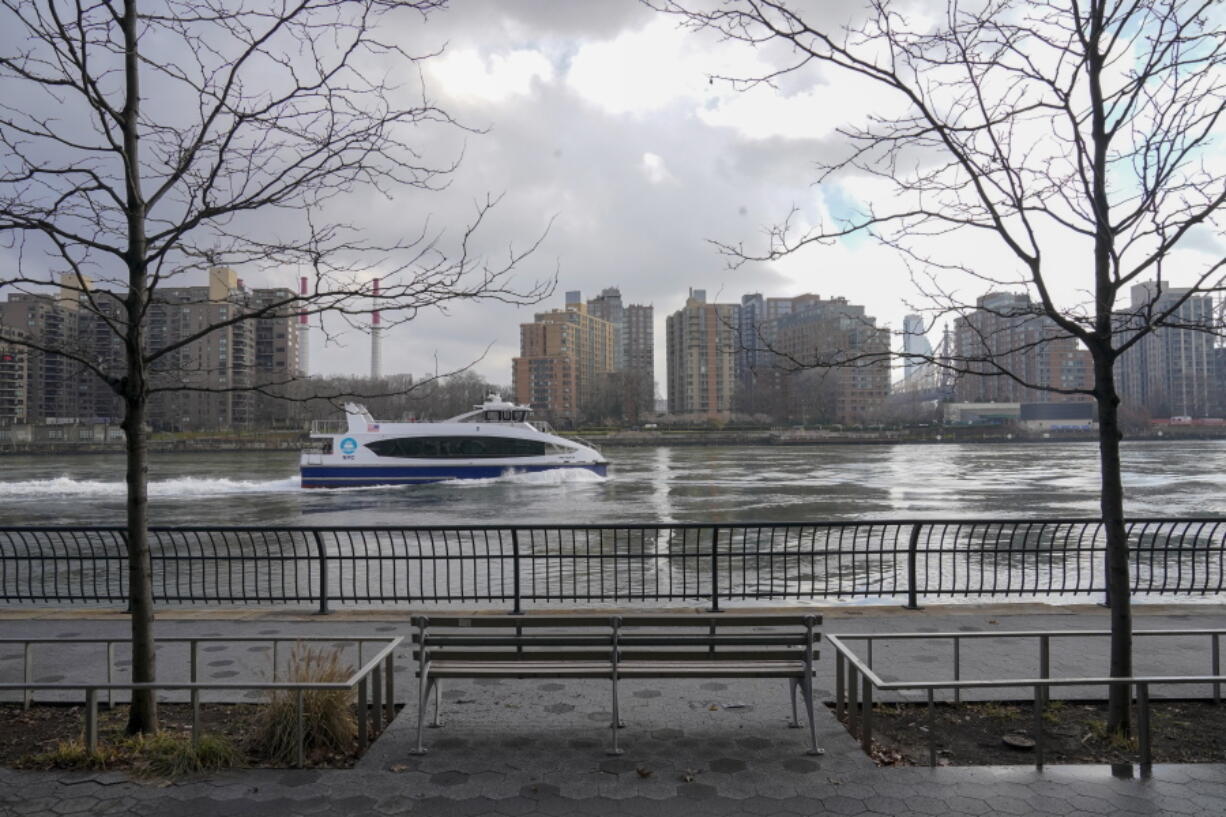 A commuter ferry makes its way down the East River on the the Upper East Side of the Manhattan borough of New York on Friday, Jan. 6, 2023, where woolly mammoth tusks were allegedly dumped in the mid 1900s.