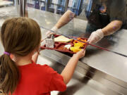 A Washougal School District employee  prepares food for students and employees.