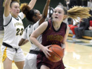 Prairie’s Claire Smith, right, spins past Evergreen defenders Adrian Wright, left, and Lavalerie Lindsey on Wednesday, Feb. 1, 2023, at Evergreen High School.