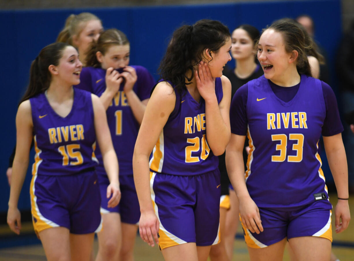 Columbia River freshman Gracie Glavin (33) talks to Columbia River junior Emma Iniguez, center, after the Rapids' win against Ridgefield in January.