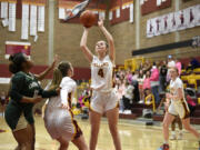 Prairie’s Claire Smith, center, gets ready to release a shot during a Class 3A bi-district game against Timberline on Friday, Feb. 10, 2023, at Prairie High School.