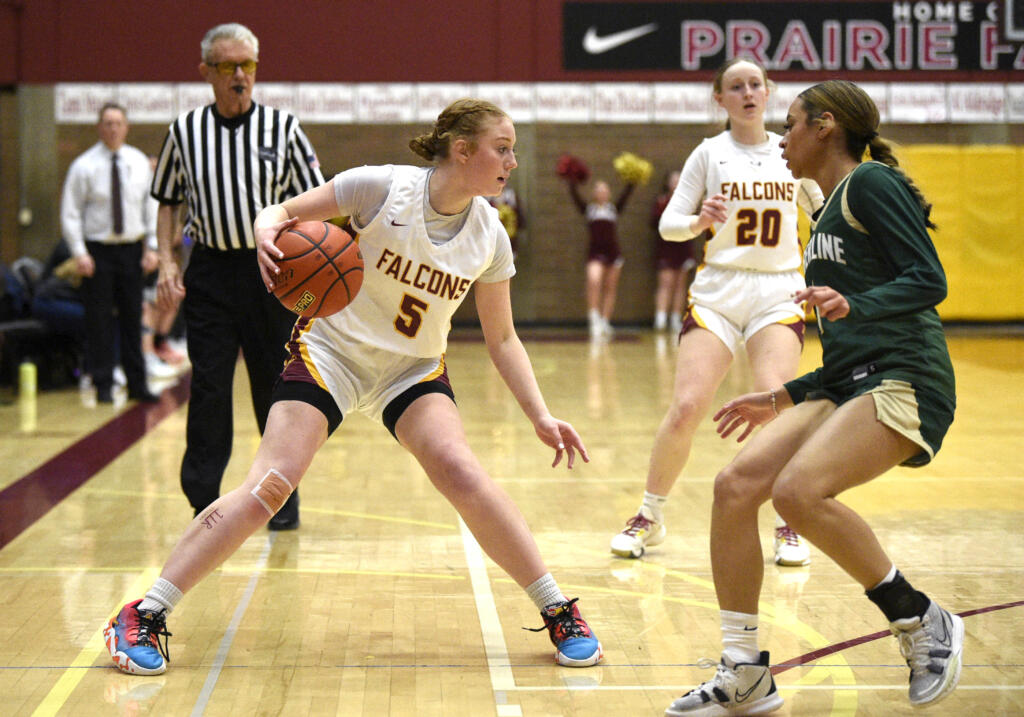 Prairie’s Emma Smith, left, dribbles while being defended by Timberline’s Shayla Cordis in a Class 3A bi-district game on Friday, Feb. 10, 2023, at Prairie High School.