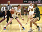 Prairie’s Emma Smith, left, dribbles while being defended by Timberline’s Shayla Cordis in a Class 3A bi-district game on Friday, Feb. 10, 2023, at Prairie High School.