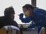 A nurse, right, attends to a non-COVID patient at Emanate Health Queen of the Valley Hospital on Feb. 8, 2022, in West Covina, Calif.