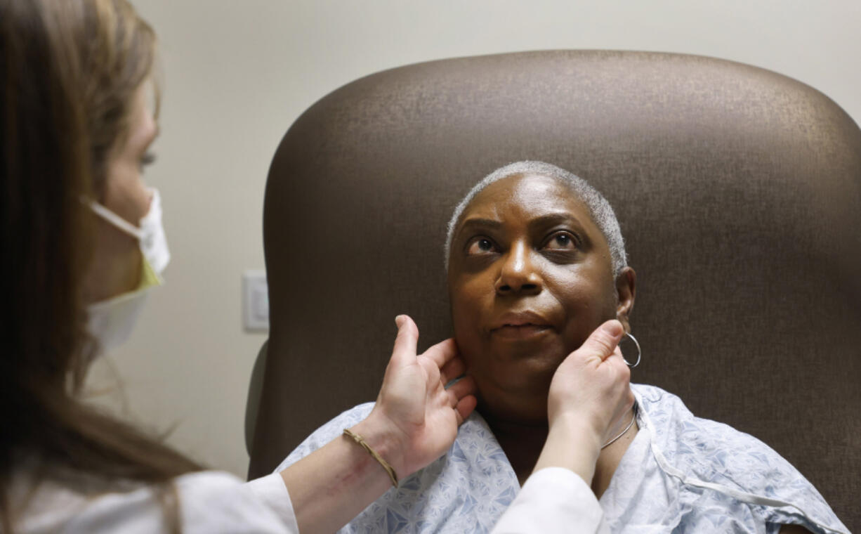 Nurse practitioner Rachel Roberts examines Stephanie Walker of Tarboro, N.C., during an appointment Feb. 2 at the Duke Cancer Clinic in Durham, N.C. For the last six years, Walker has endured painful monthly injections to help treat her cancer.