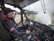 Jay Williams, a driver/engineer with the Port of Seattle fire department, sprays water from the Aircraft Rescue Firefighting Vehicle (ARFF) he is driving at Seattle-Tacoma International Airport in SeaTac on Thursday, Jan. 19, 2023. The vehicles can pump out 600 gallons a minute at low flow and 1200 gallons at high flow. (Ellen M.