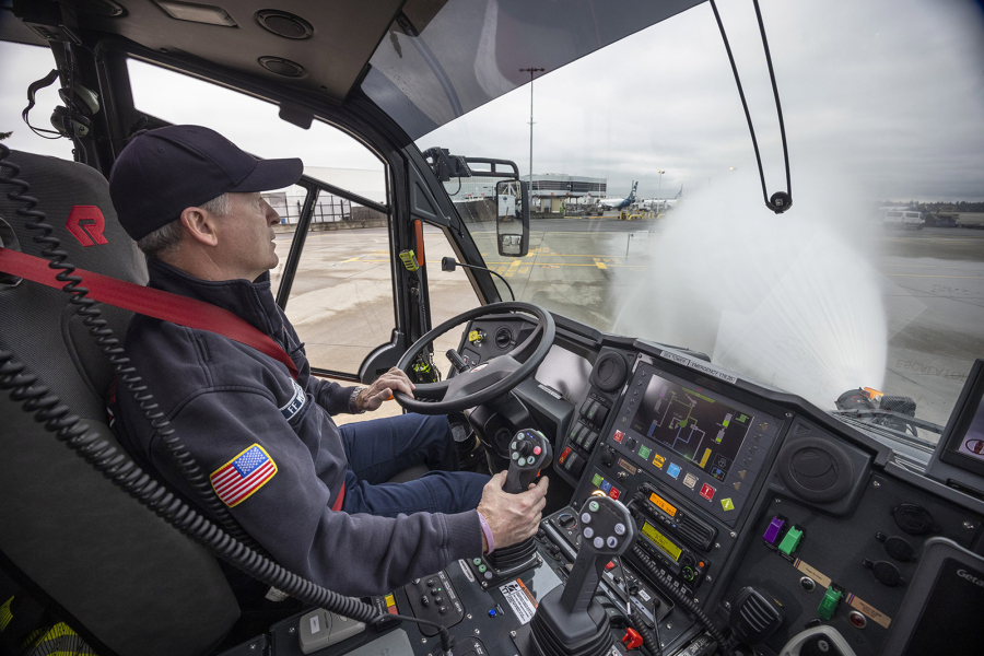 Jay Williams, a driver/engineer with the Port of Seattle fire department, sprays water from the Aircraft Rescue Firefighting Vehicle (ARFF) he is driving at Seattle-Tacoma International Airport in SeaTac on Thursday, Jan. 19, 2023. The vehicles can pump out 600 gallons a minute at low flow and 1200 gallons at high flow. (Ellen M.