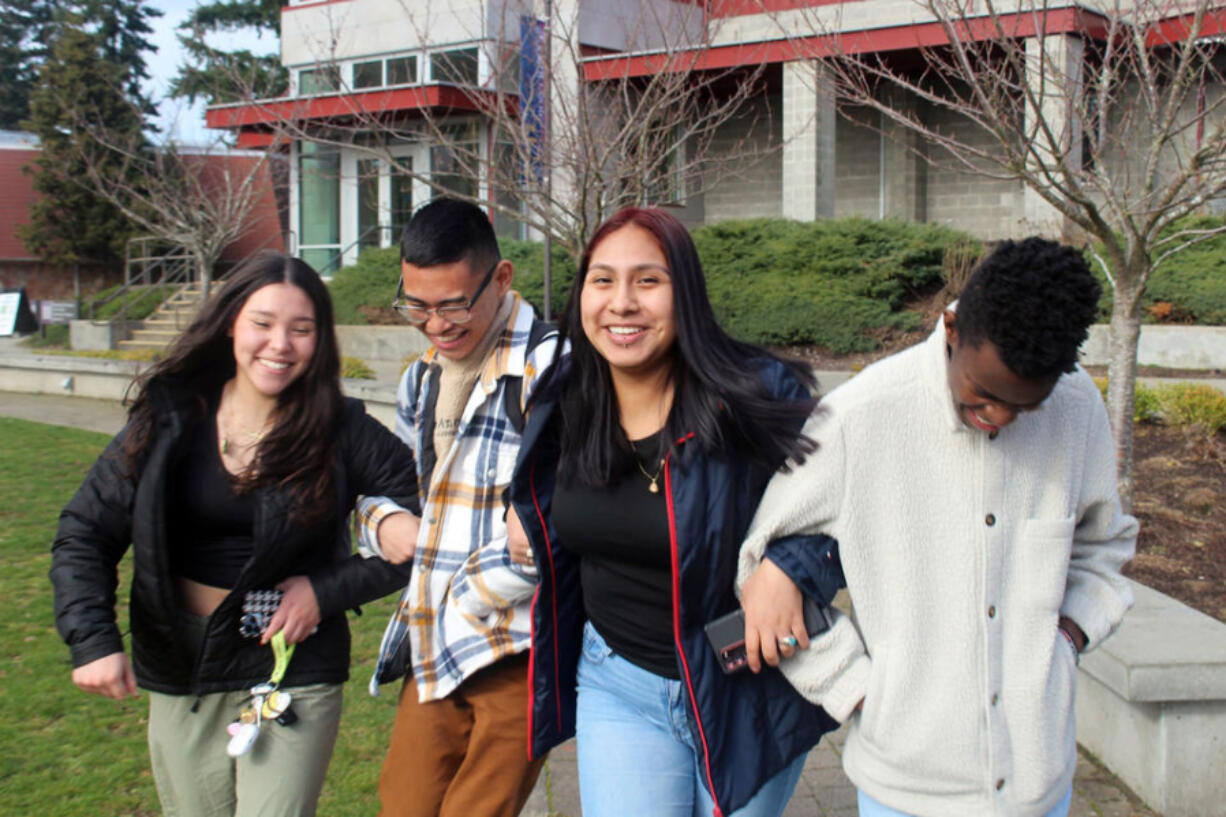 From left, Keiley Pyeatt, Philip Palpita, Margarita Sanchez, and Branton Waitiki, all age 17 and students in the Running Start program at Tacoma Community College, walk arm-in-arm in front of the student center.