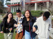 From left, Keiley Pyeatt, Philip Palpita, Margarita Sanchez, and Branton Waitiki, all age 17 and students in the Running Start program at Tacoma Community College, walk arm-in-arm in front of the student center.