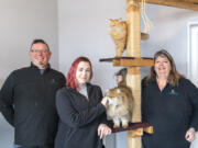 Associate facility manager Kendrick Johnsen, left, cattery assistant Aubrey Redfern, center, and owner Denise Saxon, right, are proud to serve Clark County cats like Peanut, top and June at Tiny's Place Luxury Cat Boarding in Hazel Dell.