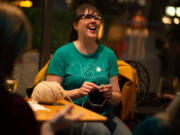 Jen Langdon laughs and knits while drinking riesling at Niche Wine Bar in downtown Vancouver. Bars are offering activities not usually associated with drinking establishments to lure customers, especially midweek.