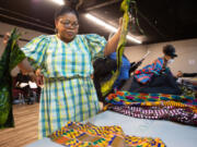 Designer Dora Darlington sorts through samples of clothing from her native Ghana at a fitting in advance of Saturday's Black History Month Fashion Show at The Lord's Gym in Vancouver.