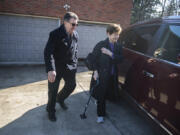 Volunteer Bruce Eavey of Villages Clark County, left, escorts Frankie Shetterly to the car while picking her up for a medical appointment. Villages Clark County helps older people stay in their homes by providing volunteers for small household tasks and errands.