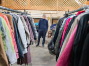 Tod Thayer, Friends of the Carpenter executive director, stands among donated coats at the organization's annual coat giveaway Tuesday, organized in partnership with the Boy Scouts of America. Thayer invited various nonprofit organizations to pick up coats to distribute to homeless and low-income clients.