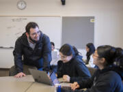 Instructor Sawyer Barragan, from left, works with freshman Isela Bonilla and sophomore Nayeli Lopez-Martinez during their University 250 class at Washington State University Vancouver on Thursday afternoon. The class aims to help freshmen adjust to campus life while working with an adviser to explore academic and career opportunities.