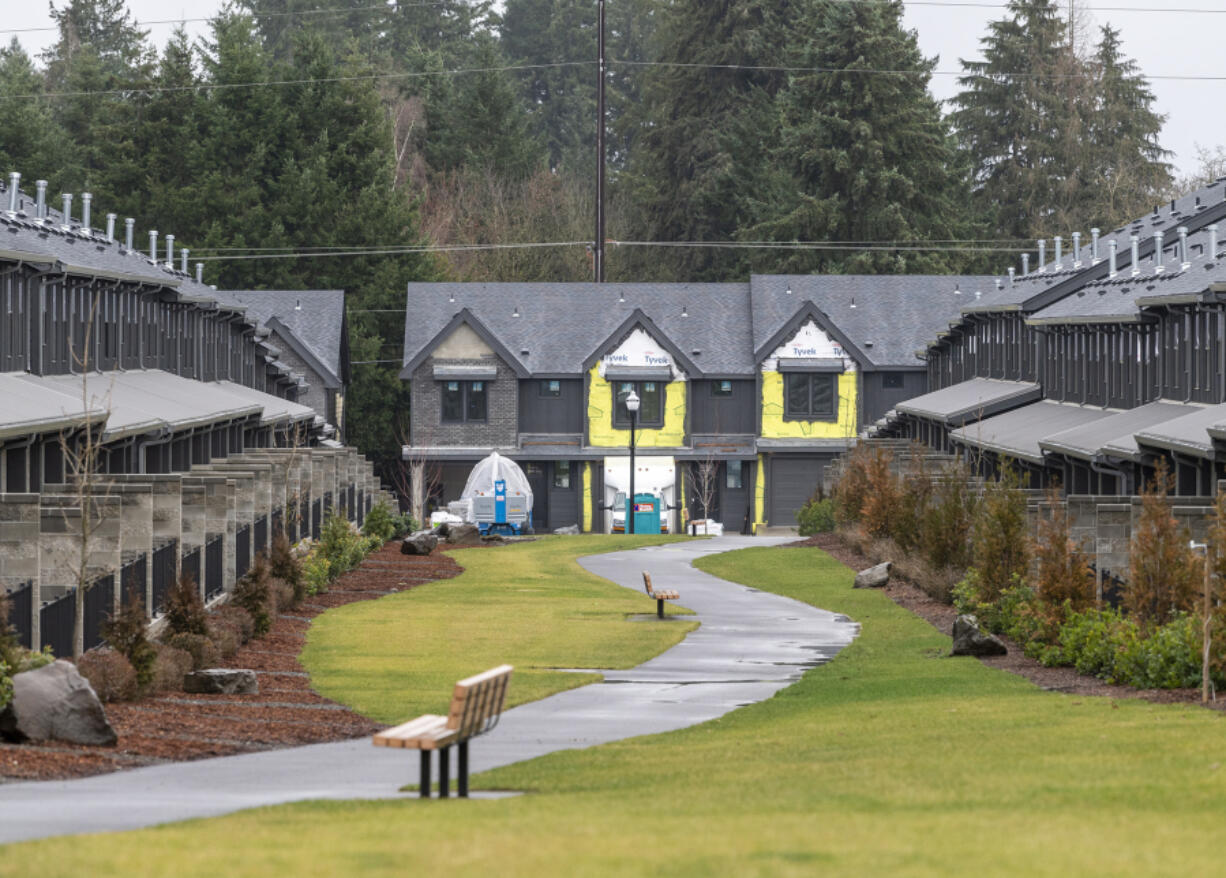 A sidewalk snakes between nearly finished town homes at The Courtyards at Hidden Crest development in Vancouver in February. Zoning districts for middle housing developments like town homes can help make way for more middle-income housing options in Clark County.