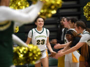 Evergreen sophomore Adrian Wright, center, smiles during player introductions Friday, Feb. 10, 2023, before the Plainsmen’s game against North Thurston at Evergreen High School.