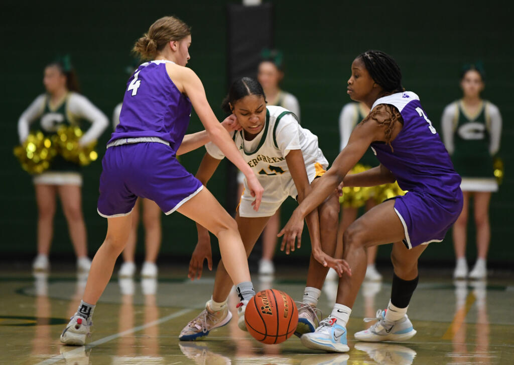 Evergreen freshman Kimora Ross, center, tries to split the defense of North Thurston sophomore Grace Lee, left, and sophomore Soraya Ogaldez on Friday, Feb. 10, 2023, during the Plainsmen’s 78-38 loss to North Thurston at Evergreen High School.