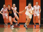 Camas junior Reagan Jamison, second from right, dribbles down the court after a late steal Friday, Feb. 24, 2023, during the Papermakers’ 52-48 win against Kamiakin at Battle Ground High School.