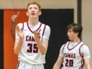 Camas freshman Ethan Harris, left, celebrates after a call Friday, Feb. 24, 2023, during the Papermakers’ 64-53 win against West Valley - Yakima at Battle Ground High School.