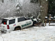 The Clark County Sheriff's Office SUV Deputy Drew Kennison was driving Wednesday stopped against a tree after part of another snow-heavy tree fell on it on Washougal River Road. Kennison underwent surgeries at area hospitals, including a partial amputation of his left leg.