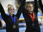 All-around champion Gretchen Lane of Prairie and runner-up Reese Velansky of Washougal (right) pose after receiving their medals at the Class 3A District 4 meet at Northpointe on Saturday, Feb. 11, 2023.