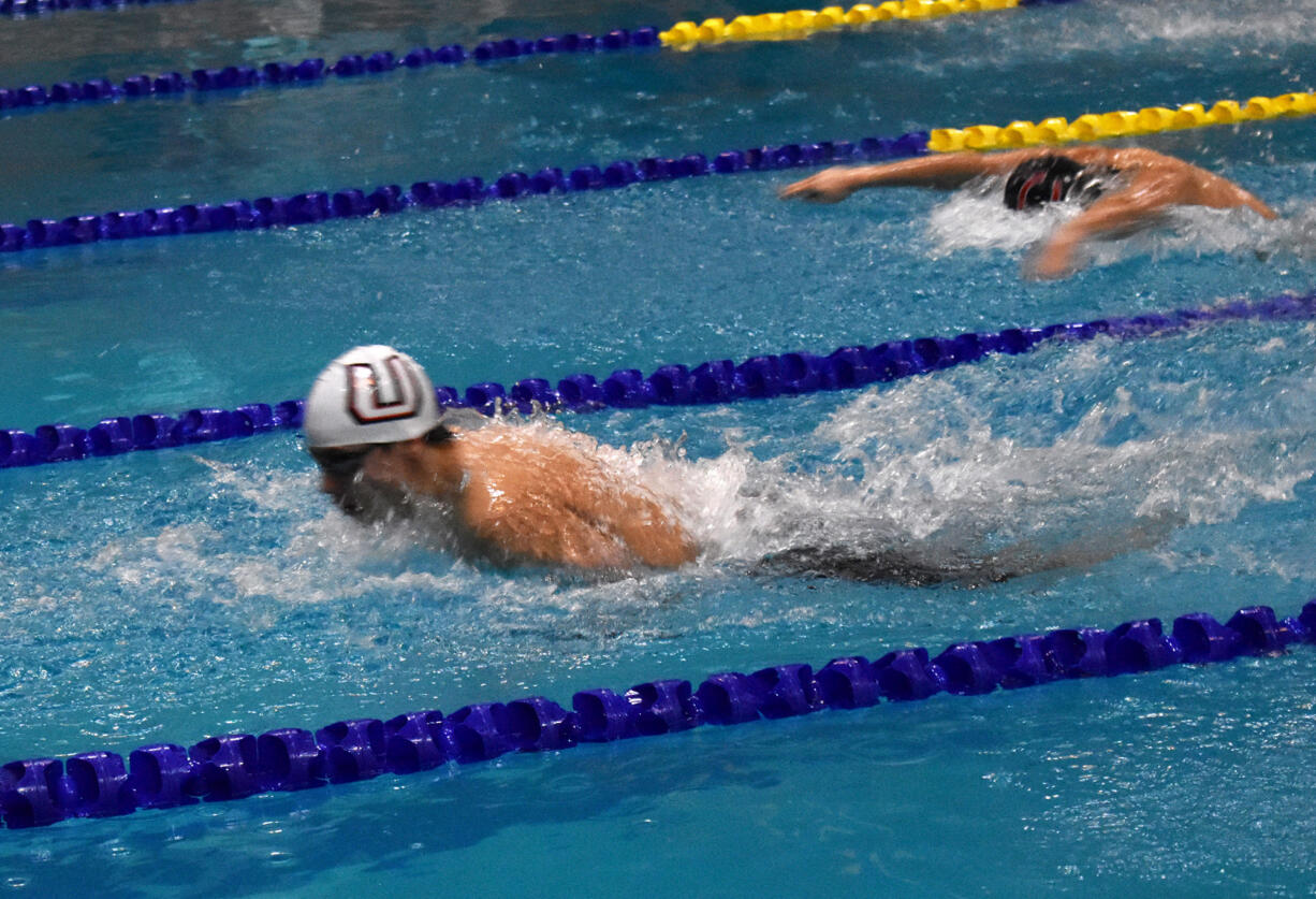 Union's Sam Empey swims to victory in the 100 butterfly at the Class 4A District 4-8 meet at Kelso High School on Saturday, Feb. 4, 2023.