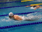 Union's Sam Empey swims to victory in the 100 butterfly at the Class 4A District 4-8 meet at Kelso High School on Saturday, Feb. 4, 2023.