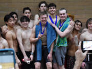 Union's 400 free relay team of Alexander Wahlman, Owen Robertson, Steven Empey and Sam Empey stand on the podium after taking first place at the 4A District 4-8 meet at Kelso High School on Saturday, Feb. 4, 2023.