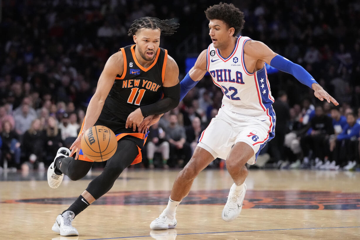 New York Knicks guard Jalen Brunson (11) dribbles past Philadelphia 76ers guard Matisse Thybulle (22) during the second half of an NBA basketball game, Sunday, Feb. 5, 2023, in New York.