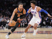 New York Knicks guard Jalen Brunson (11) dribbles past Philadelphia 76ers guard Matisse Thybulle (22) during the second half of an NBA basketball game, Sunday, Feb. 5, 2023, in New York.